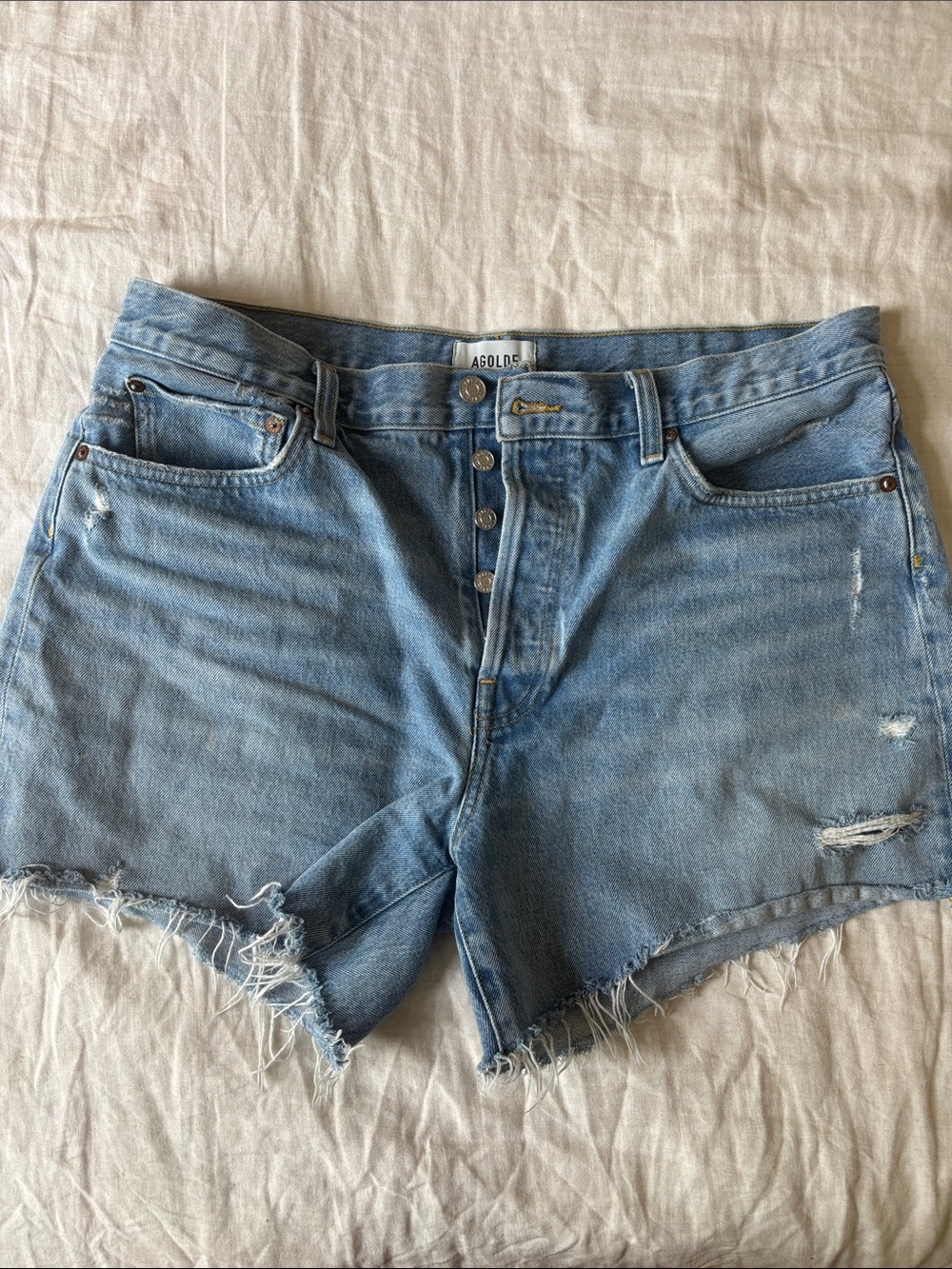Agolde Light Wash Distressed High-Rise Jean Shorts color: Swapmeet